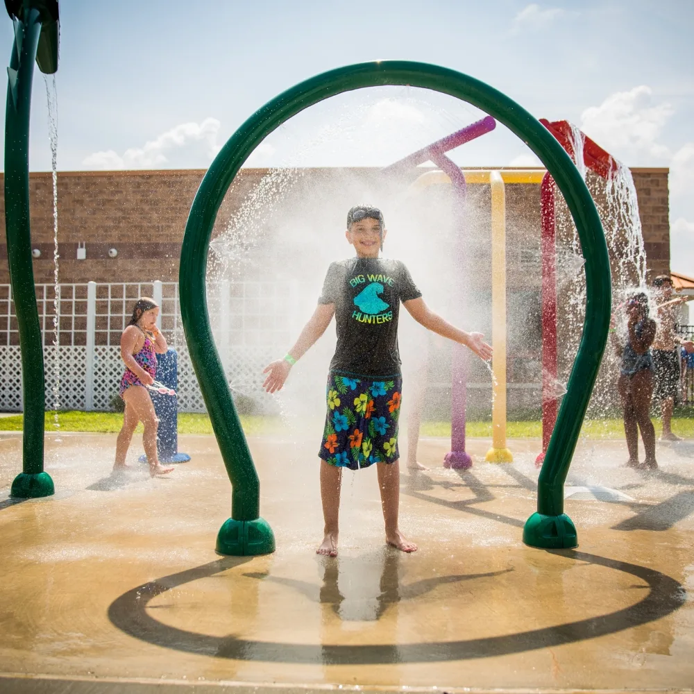 Children playing at splash pad at Ambler Y's outdoor pool