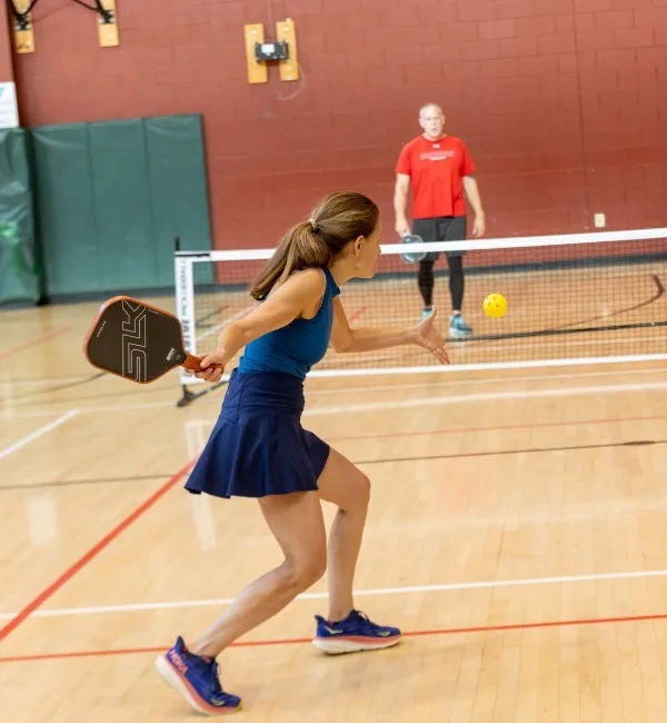 Members playing pickleball inside gymnasium at Ambler Y