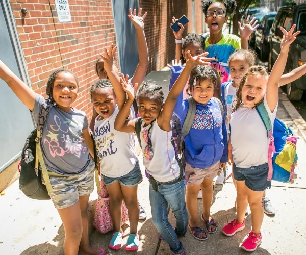 Group of summer campers posing outdoors at Ambler Y's summer camp