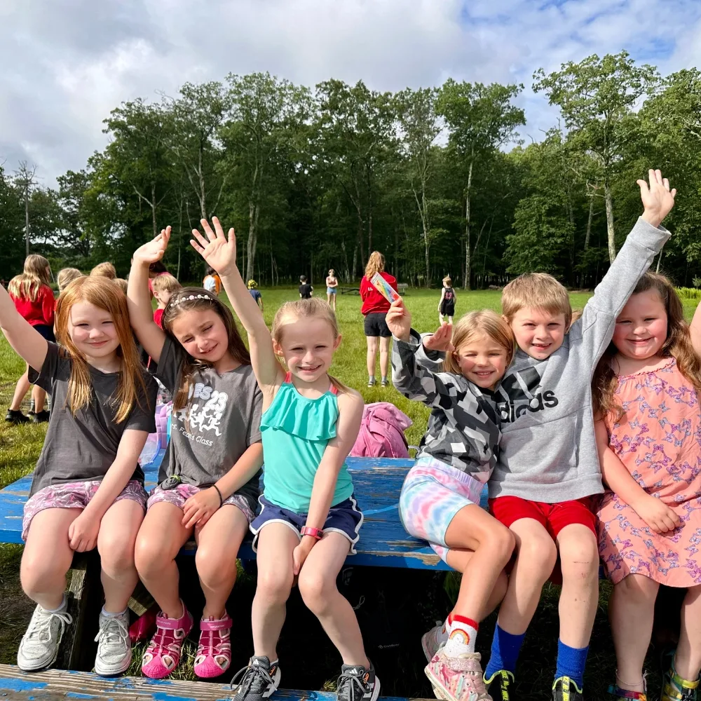 Campers sitting on a bench outdoors