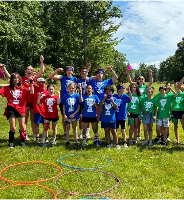 Group of campers playing team games outdoors at Camp Speers