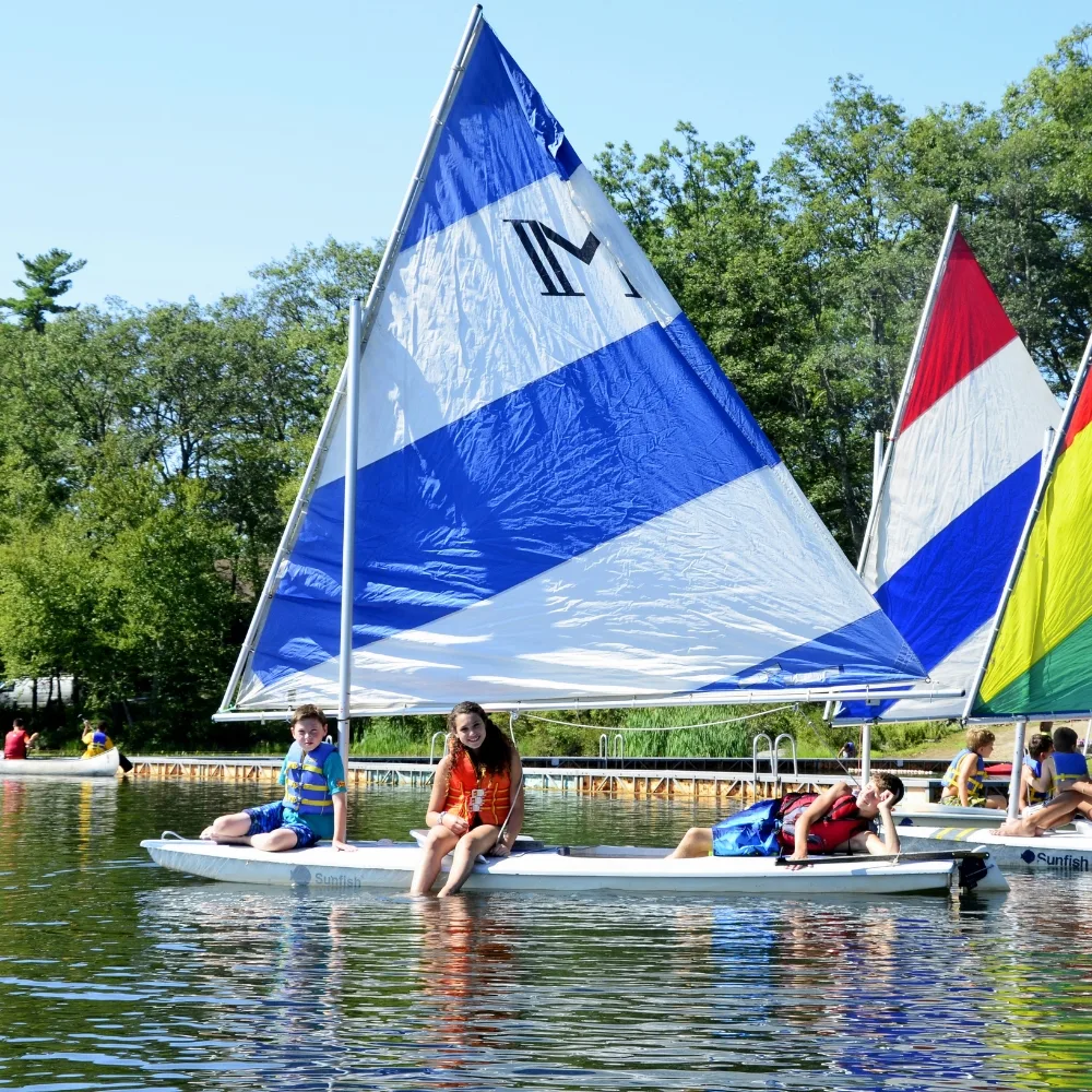 Campers sitting on raft on a lake at Camp Speers