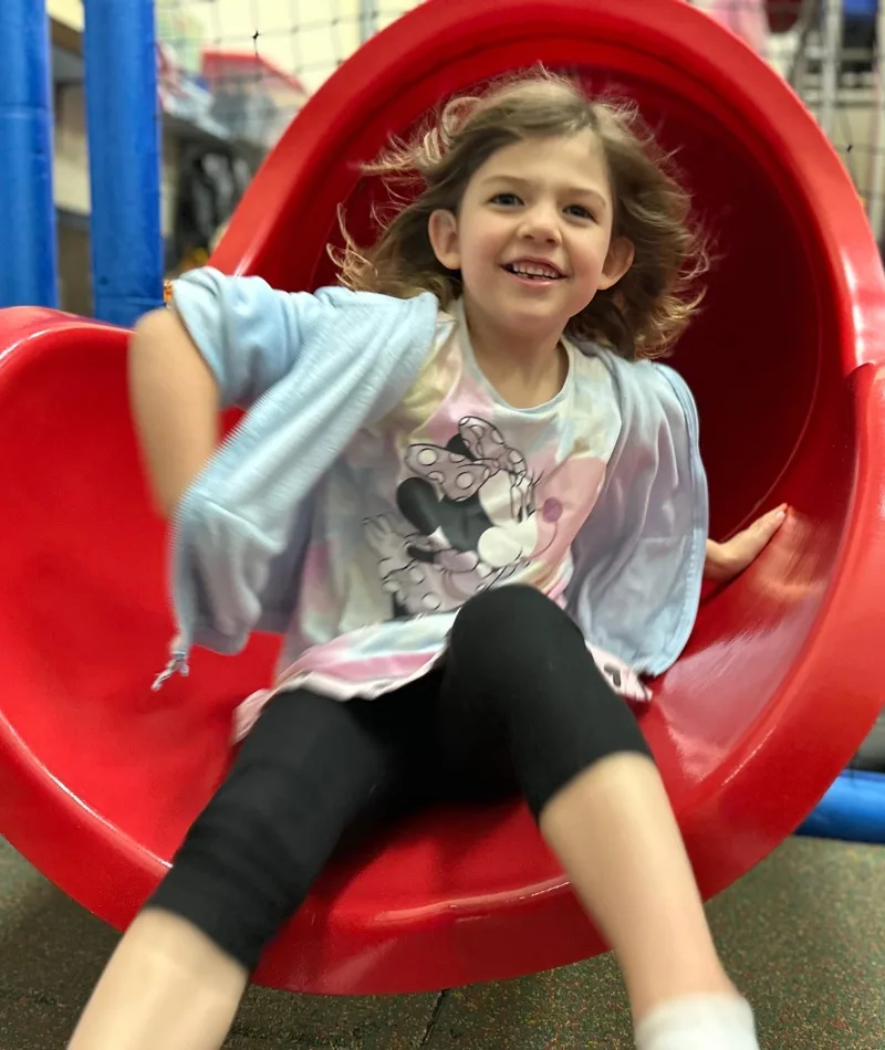 Child on slide at Abington Early Learning Center