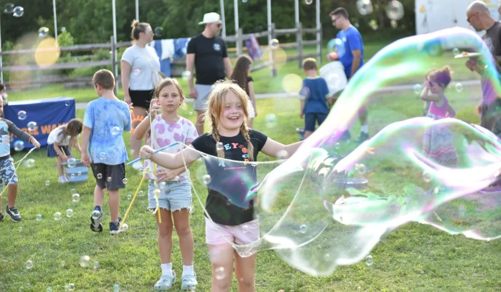 Campers playing with bubbles outdoors