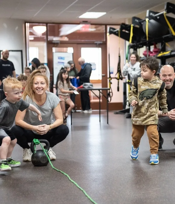 Parents and children utilizing fitness center