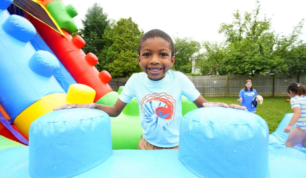 Child playing on bouncy castle outdoors
