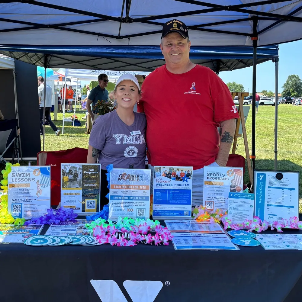 Y staff members tableting at an outdoor community event