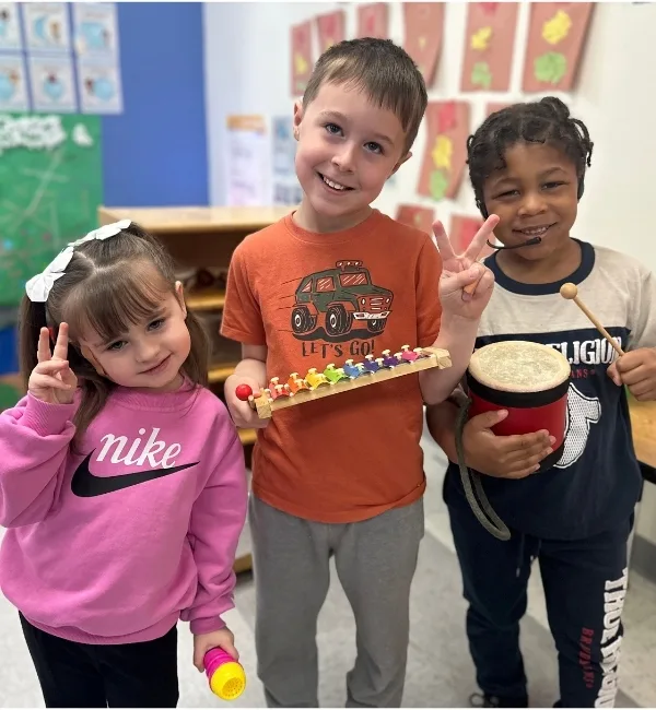 Children playing with instruments inside a classroom