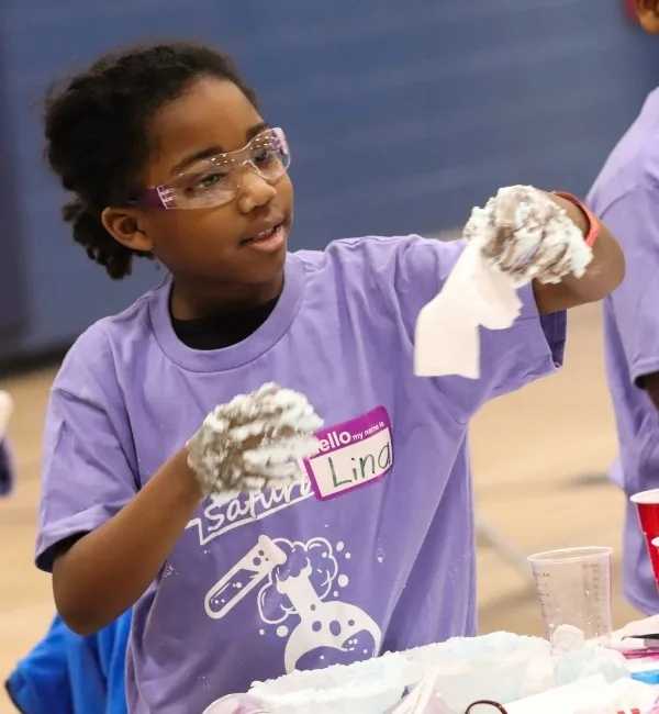 Child doing STEM crafts inside gymnasium