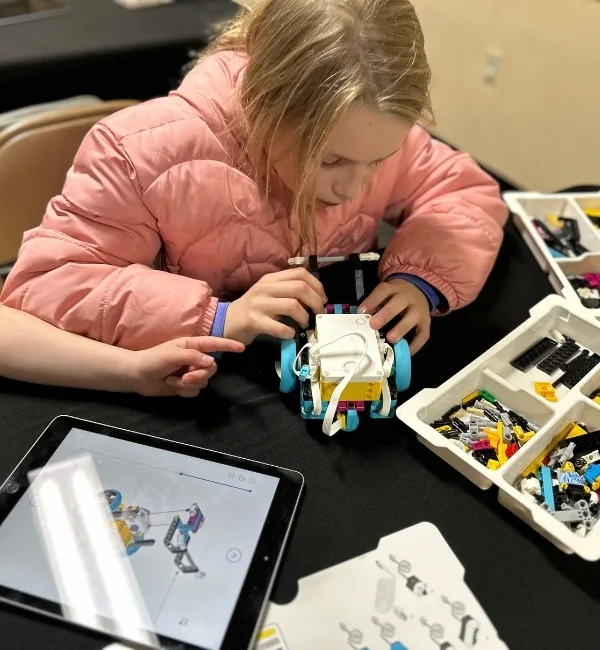 Child playing with LEGO robotics parts