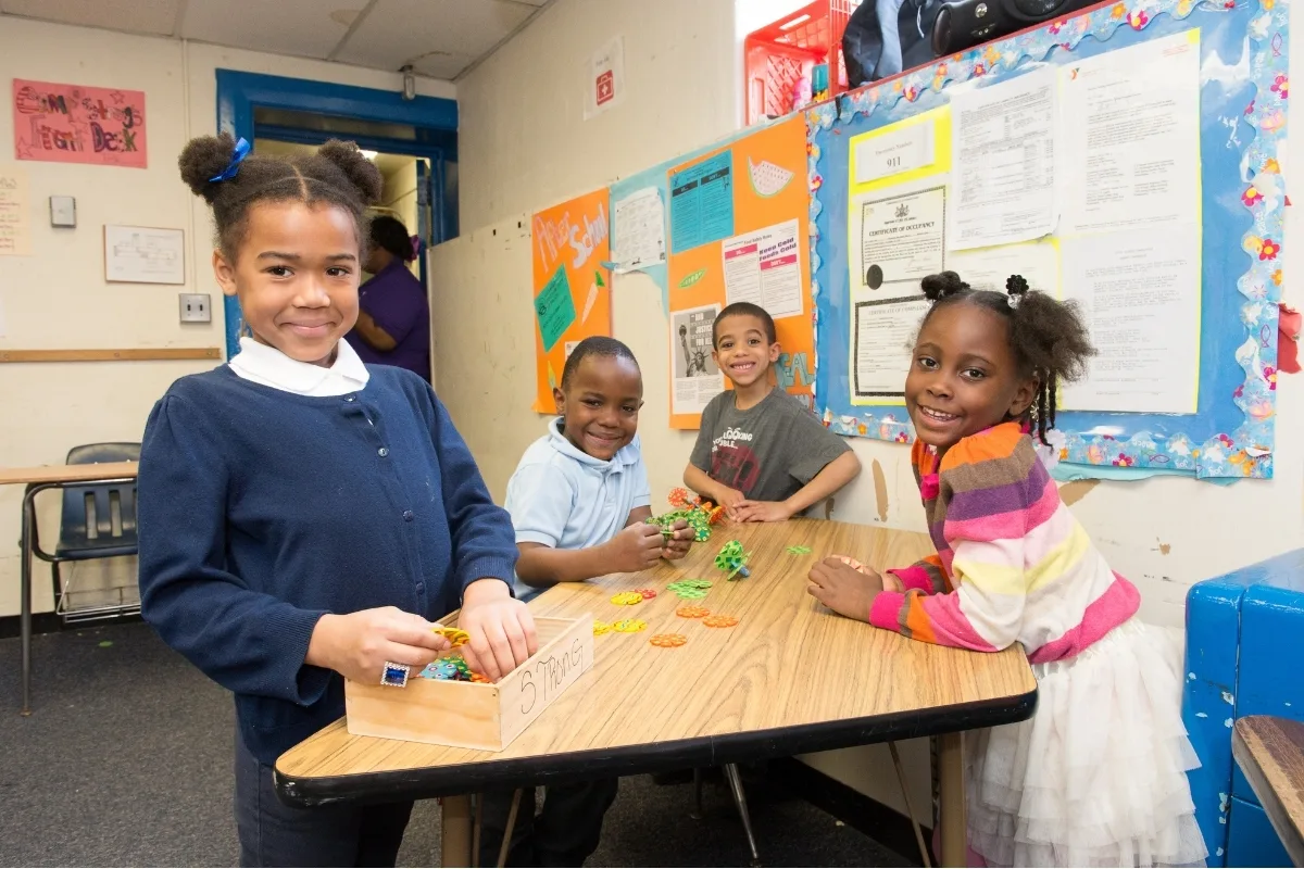 Children playing with toys inside classroom during Before and After School Care program