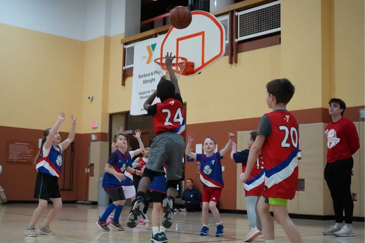Youth basketball teams playing on indoor basketball court