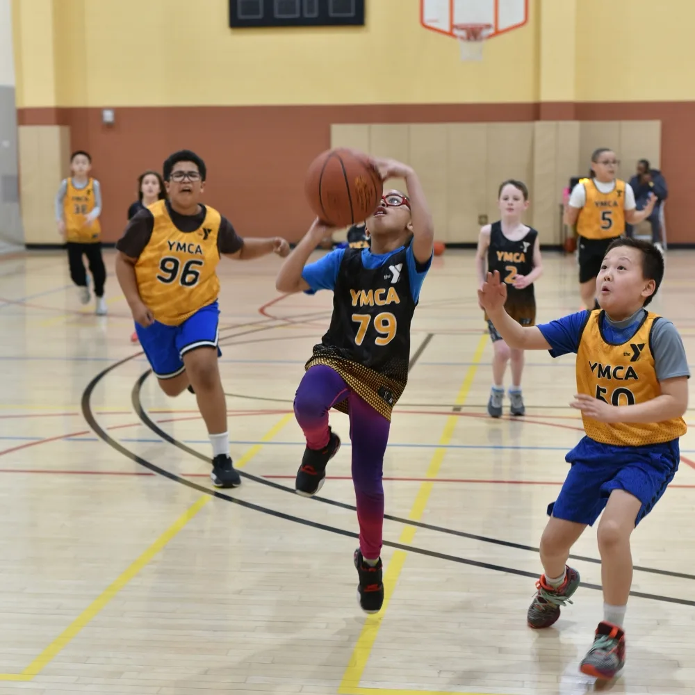 Youth basketball teams playing on indoor basketball court