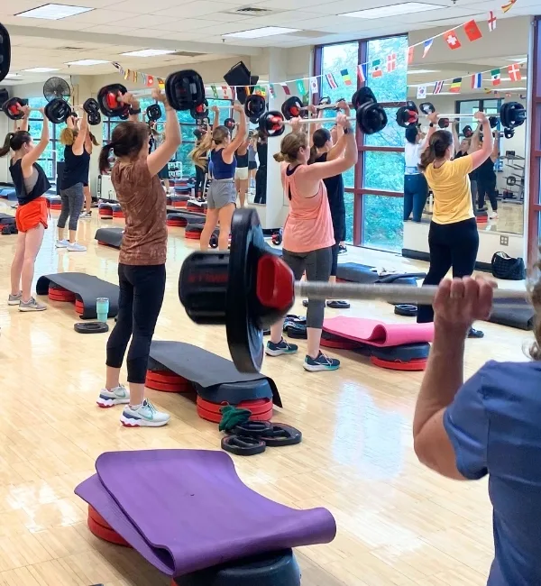 Group exercise weight training class inside studio