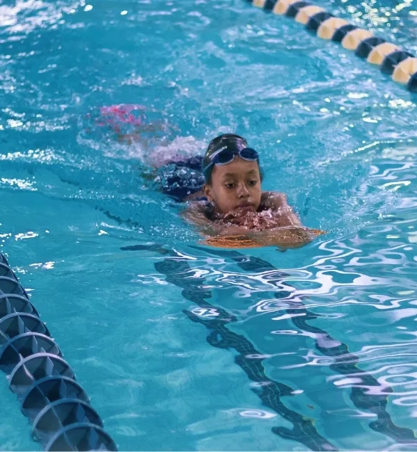 Member doing strokes inside indoor pool at West Philadelphia Y