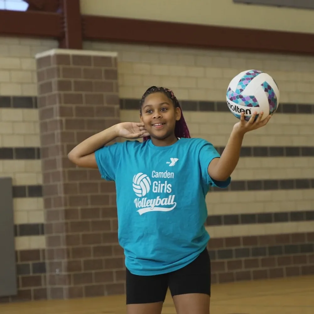 Camden Youth Volleyball team member holding a volleyball