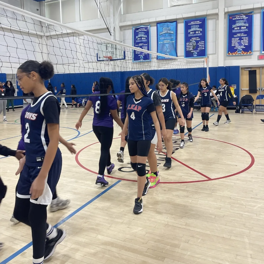 Camden Community Volleyball team at a competition inside indoor gymnasium