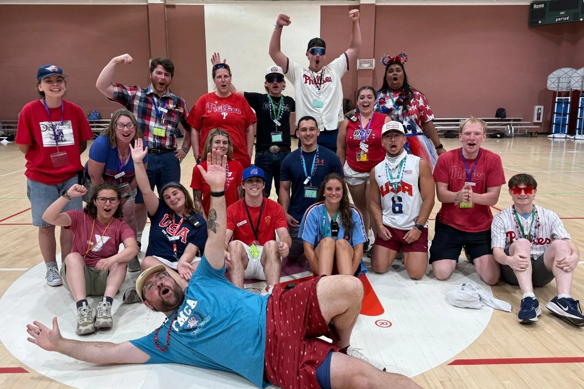 Group of camp counselors posing inside a gymnasium