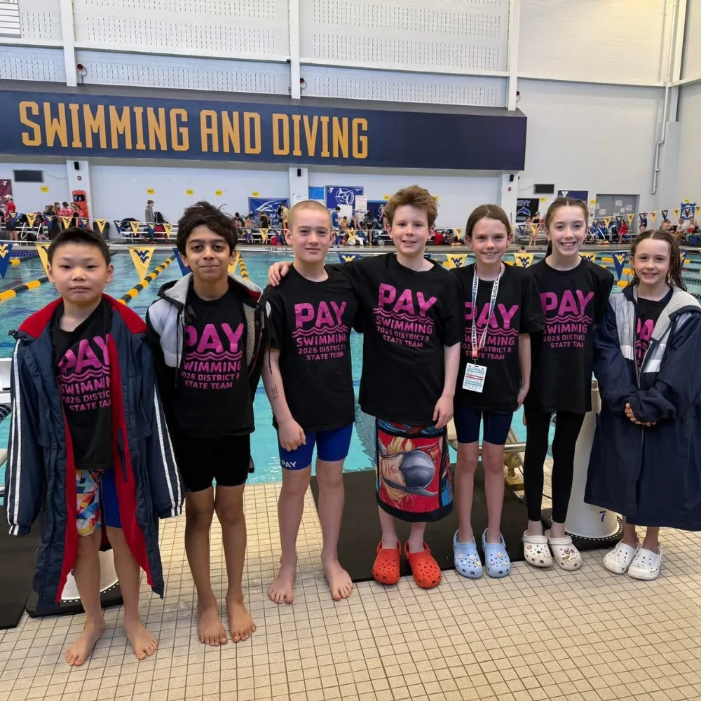 Phoenixville Y's youth swim team at competition inside indoor pool
