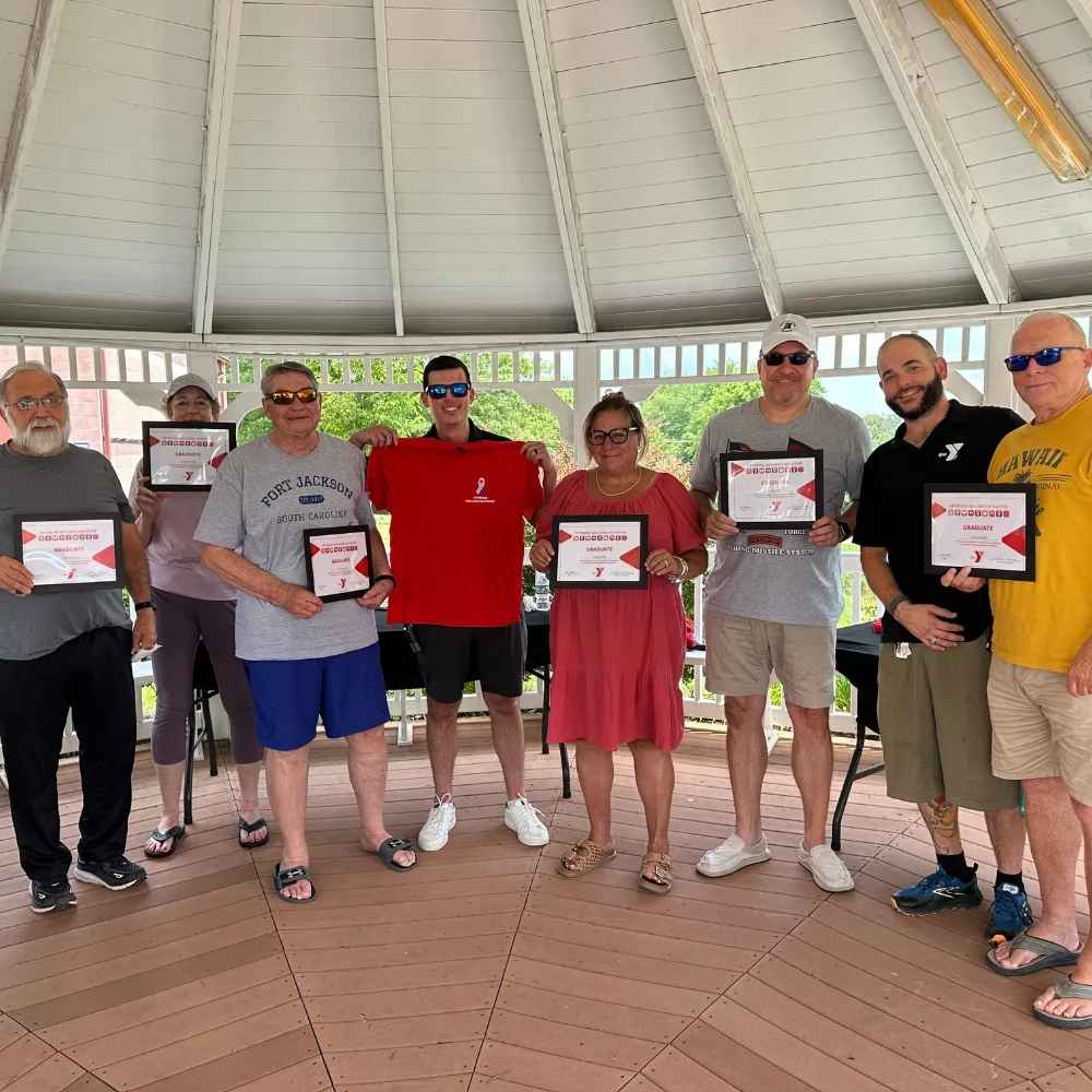 Group of people standing under gazebo at Spring Valley Y's Veterans Wellness event