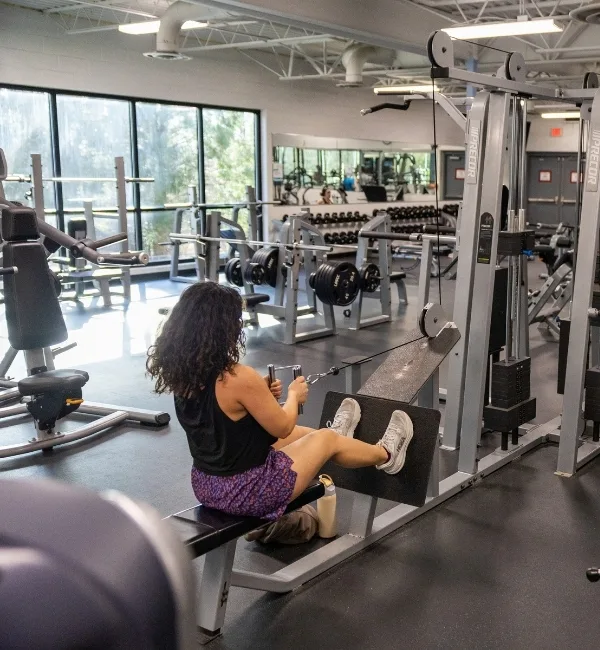 Member using pulling exercise machine at fitness center