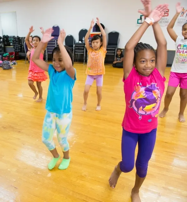 Children practicing a dance in a studio