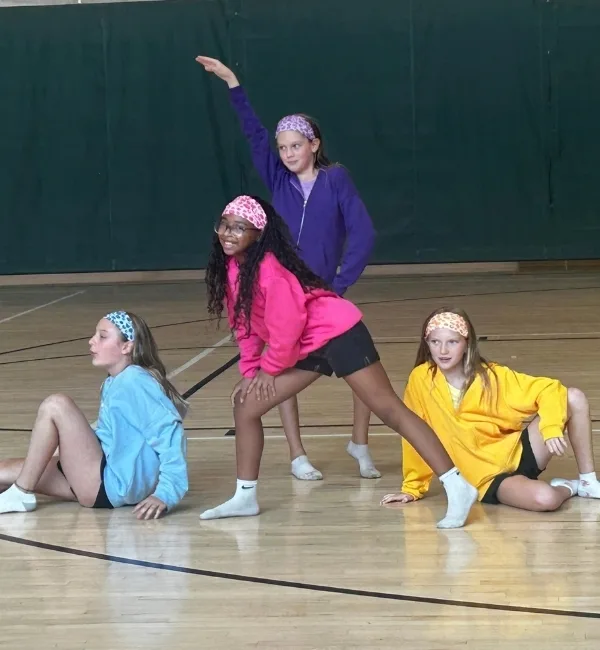 Youth dancers performing in a gymnasium