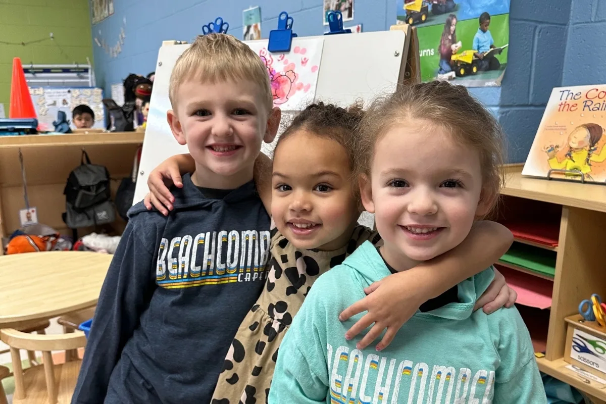 Children posing together inside a classroom