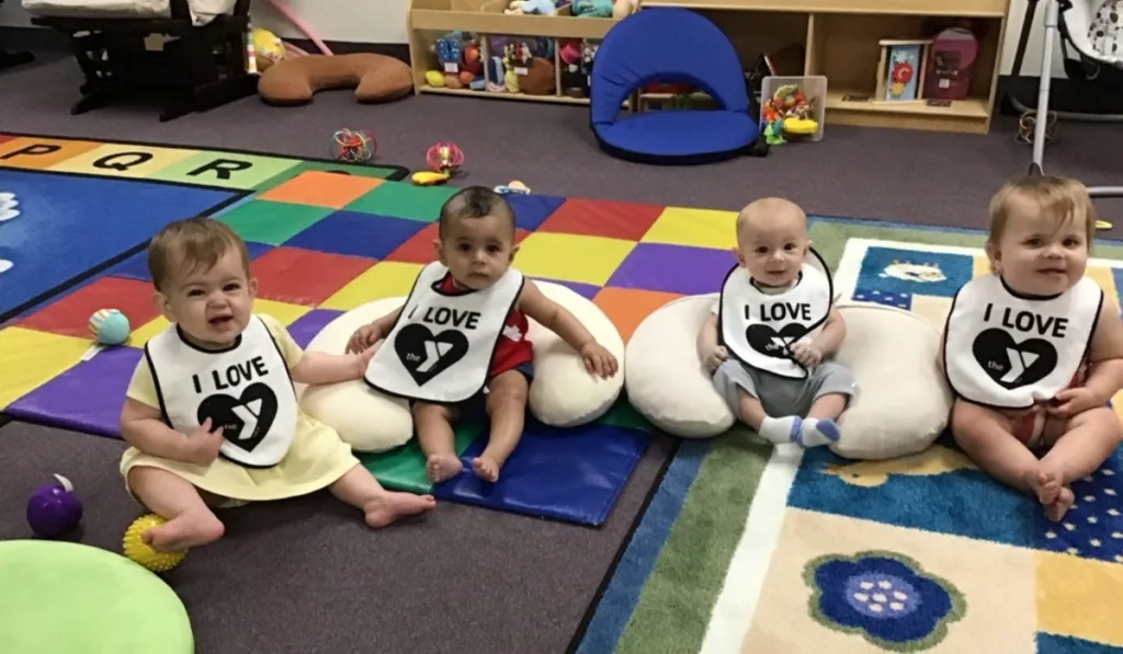 Infants sitting on floor in child care room