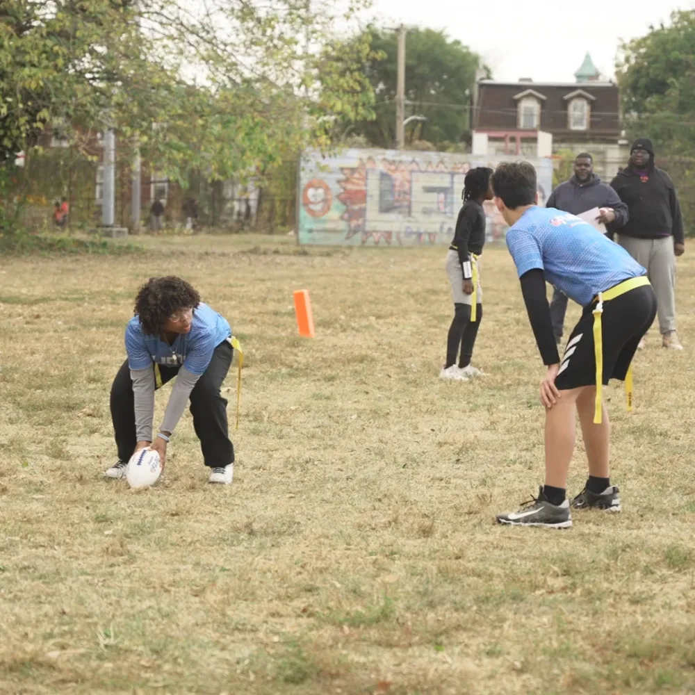 Youth playing flag football outside