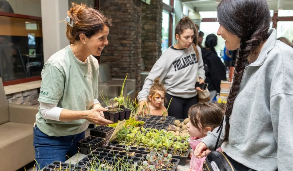 Y staff member tabling at a gardening community outreach event