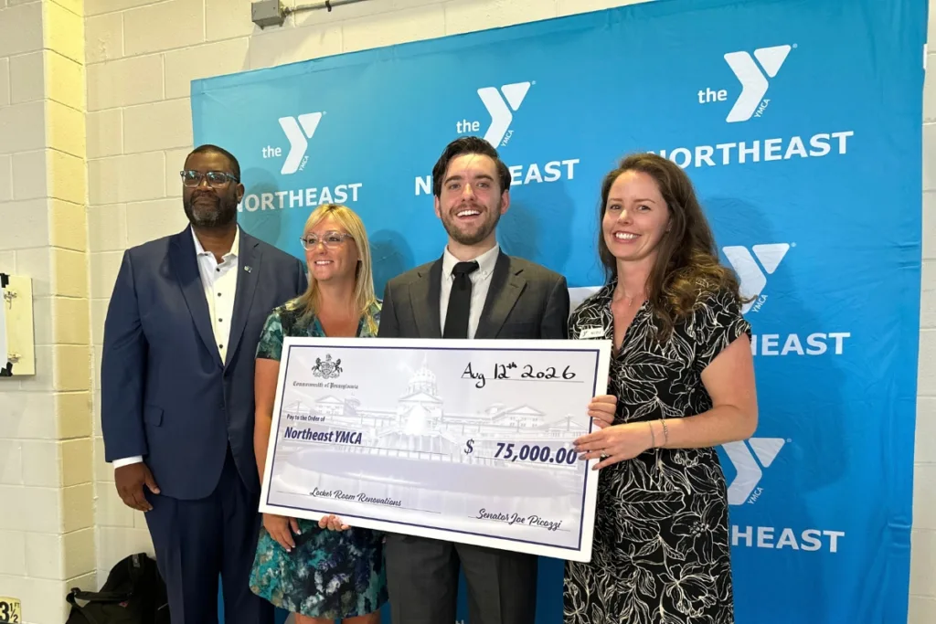 Y staff members accepting donations for facility renovations
