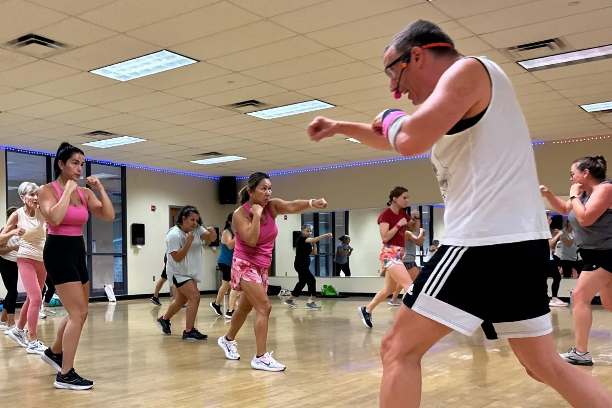 Group body combat class inside studio
