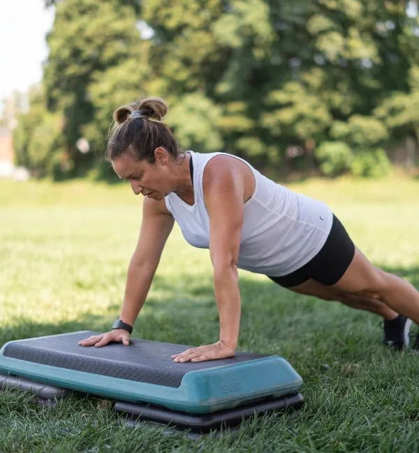 Person doing plank on board outdoors