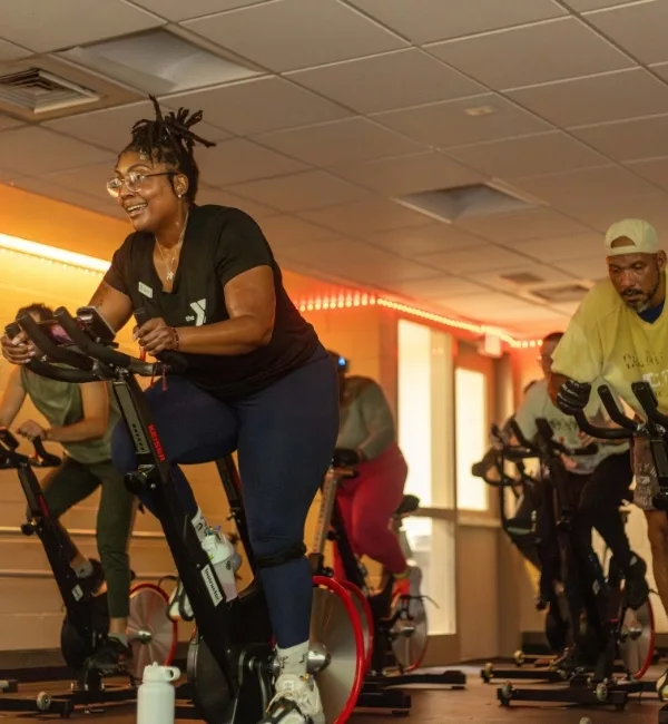 Instructor lead cycling group exercise class in a studio