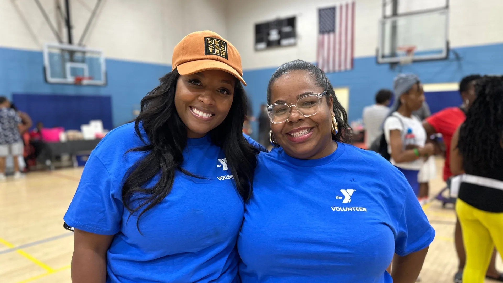 Volunteers at community outreach event inside gymnasium