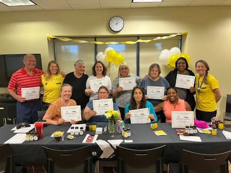 Group of people at a Livestrong event inside recreational room