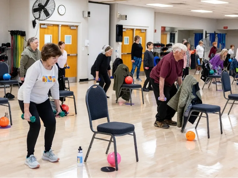 Group chair exercise in studio