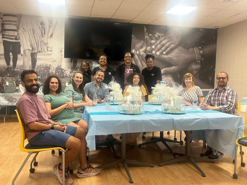 Group of people at Maternal Wellness event inside recreational room