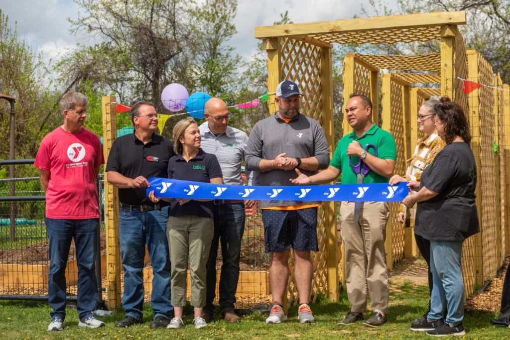 Group of people at an outdoor ribbon cutting ceremony