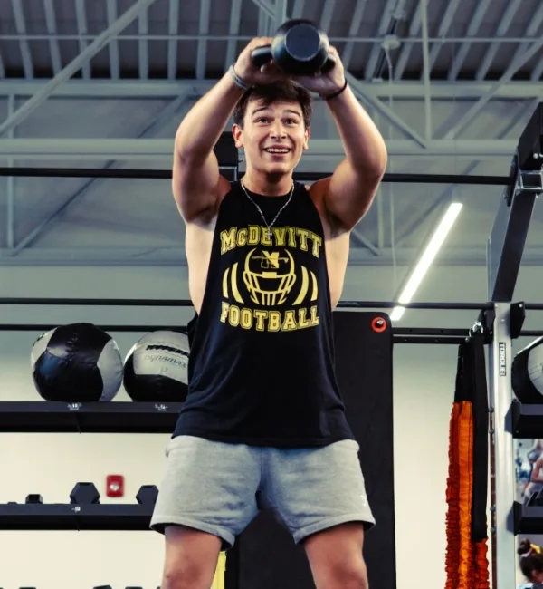Member using kettlebell inside fitness center