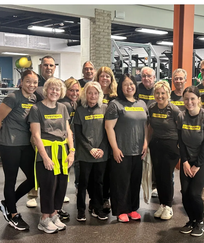 Group of members participating at a Livestrong event inside fitness center