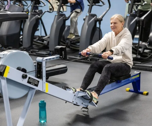 Member using rowing machine inside Montco fitness center