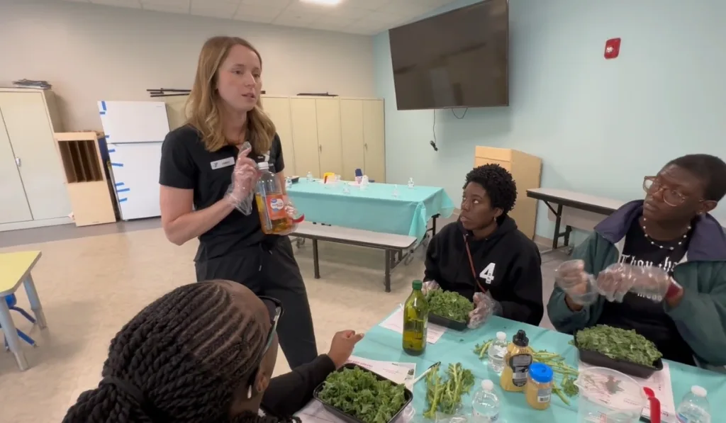 Maternal Wellness trainer giving class about nutrition and making food inside a recreational room