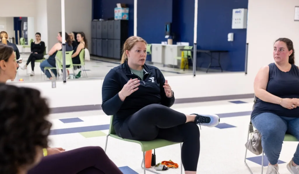 Maternal Wellness personal trainer speaking to members inside a studio