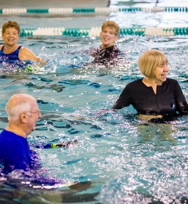 Group aquatics exercise class inside indoor pool