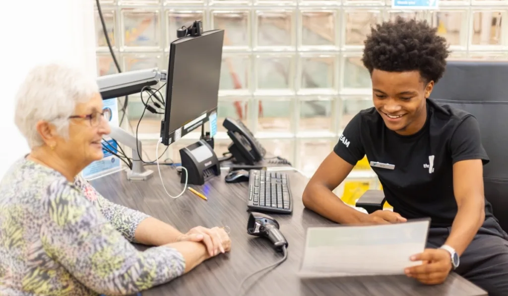 Y staff member helping member at desk