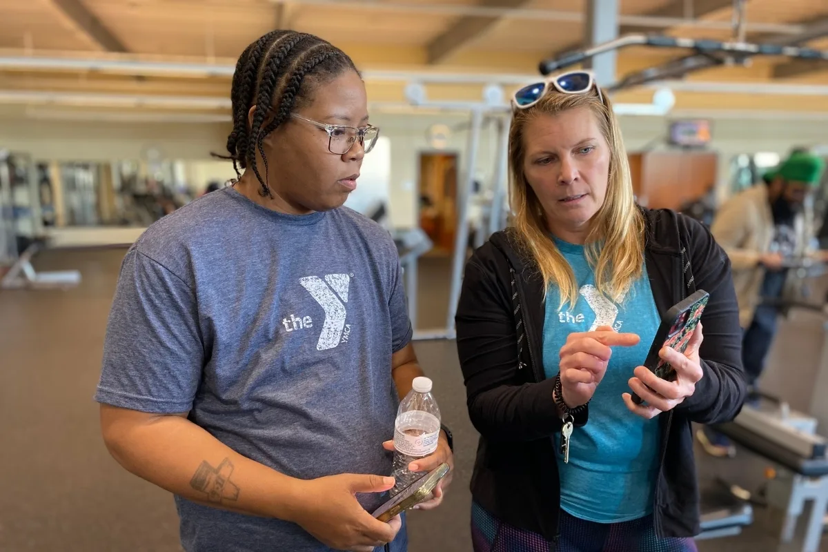 Y staff members talking inside fitness center