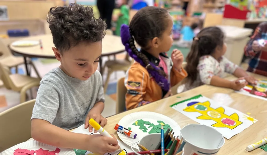 Children doing arts and crafts inside classroom