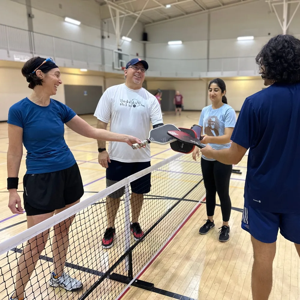Members meeting to play pickleball inside gymnasium